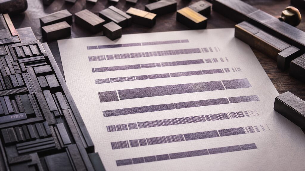 Macro editorial photograph of metal type, spacing blocks and a beautifully aligned printed proof under raking light
