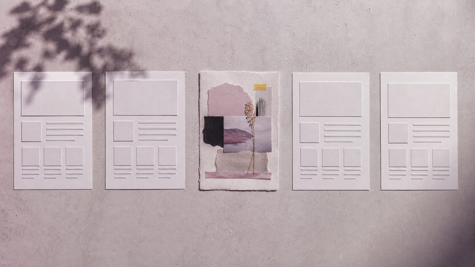 Row of nearly identical paper website maquettes interrupted by one tactile, characterful composition made by hand