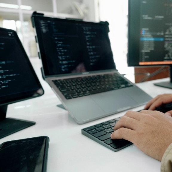 a developer working on three screens