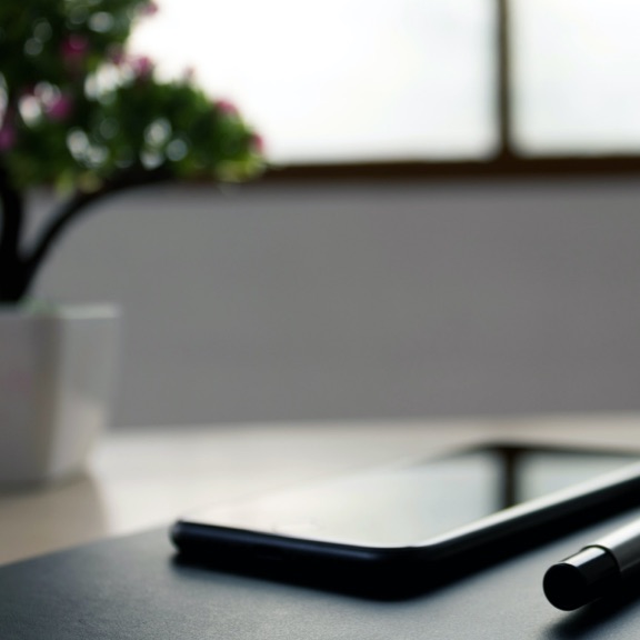 atmospheric shot of a pen on a laptop lid